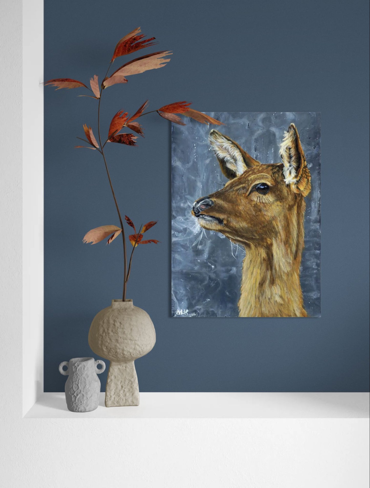 Wall mockup of the original acrylic painting "Frozen in Time" by Abigail Hemmings, showing a startled doe with frosty breath against a stormy grey background.